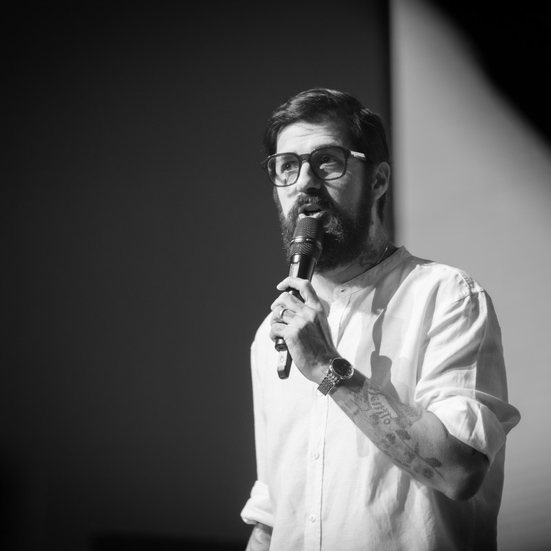 Raul Juarez speaking into a microphone at an event